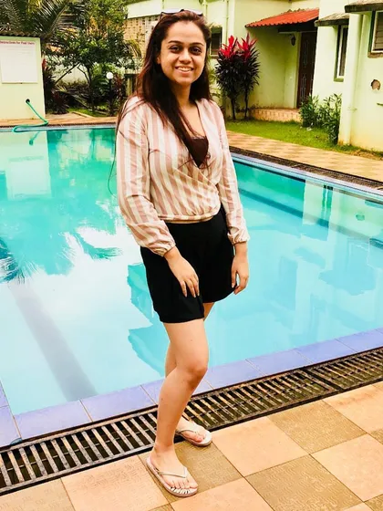 I love wearing stripes on vacation. This striped wrap top helps create a taller, leaner silhouette and is perfect for a poolside look when paired with simple black shorts.