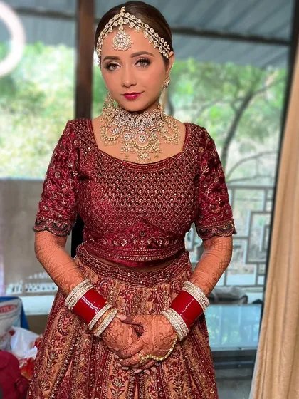 A confident and beautiful bride. The makeup is classic and elegant, designed to last through all the ceremonies and celebrations of her big day.