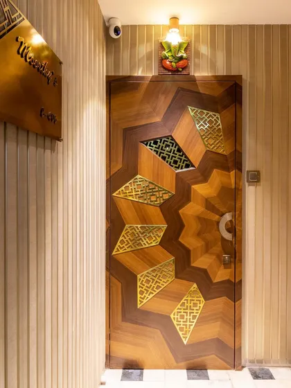 First impressions are everything. We designed this custom main door with intricate geometric patterns in wood and brass, setting a tone of bespoke elegance and craftsmanship from the moment you arrive home.