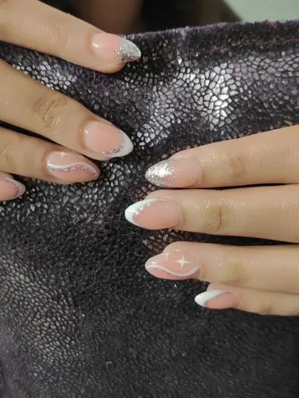 A close-up of the glitter French manicure, showing the clean lines and sparkling tips.