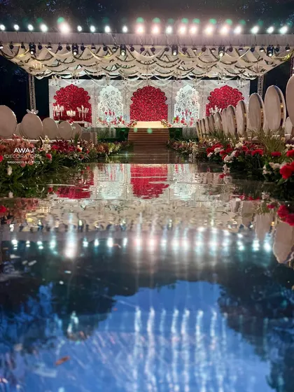 A low-angle shot of the mirrored aisle, capturing the stunning reflections of the stage and the evening sky.