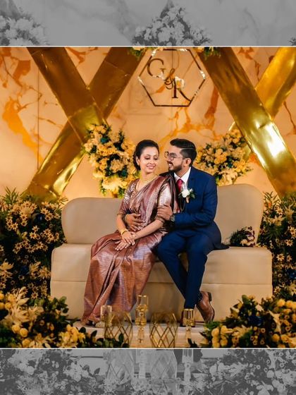 Rijo and Gigi share a quiet moment on their stunning reception stage. The backdrop of gold geometric lines on a marble-finish wall, surrounded by florals, created a modern and sophisticated look.