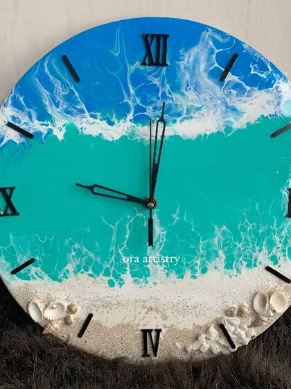 A close-up of an ocean-themed clock, showing the lacing effect of the white resin to create realistic sea foam.