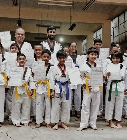 A proud moment for these young martial artists. Celebrating with their new belts and certificates after successfully passing their color belt exam. Each belt represents a new level of skill and commitment.
