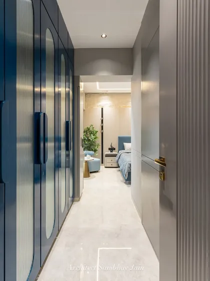 A thoughtfully designed passage that leads you into the bedroom, defined by blue PU shutters paired with fluted glass. This combination brings both privacy and a sense of openness, with a cozy nook tucked within the layout.