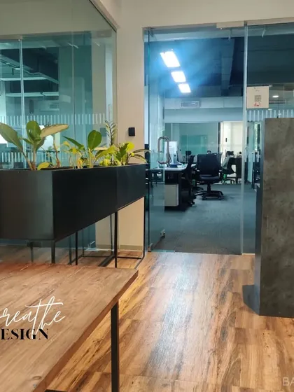 Bringing the outdoors in. We used a combination of wood tones, grey surfaces, and indoor planters to create a refreshing and productive office environment.