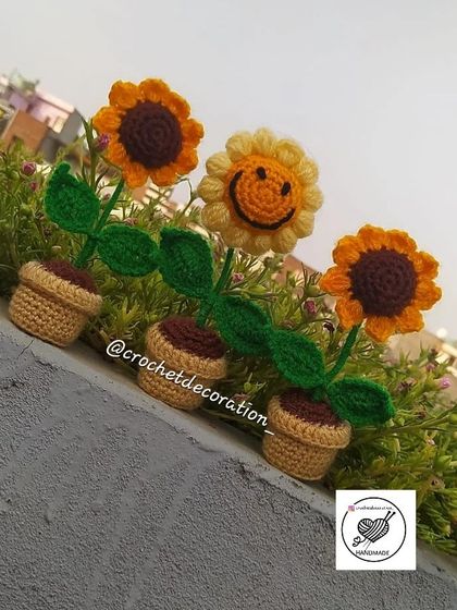 A lineup of our mini crochet sunflower pots. You can choose between the classic sunflower design or the smiley face version to create your own little garden.