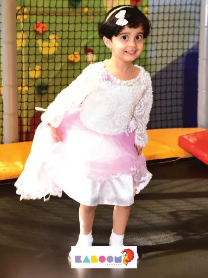 A princess on the trampoline! Jumping high and having a great time in our safe, netted trampoline area.