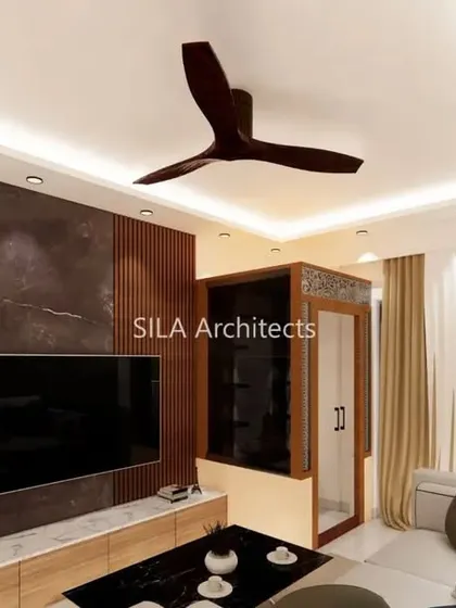 This view focuses on the TV and entertainment unit in the JP Nagar home, featuring a dark marble-finish wall that creates a bold focal point in the room.