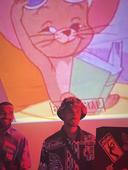 A candid moment with a classic Jerry cartoon projected in the background. Sometimes the vibe is just chill and fun.
