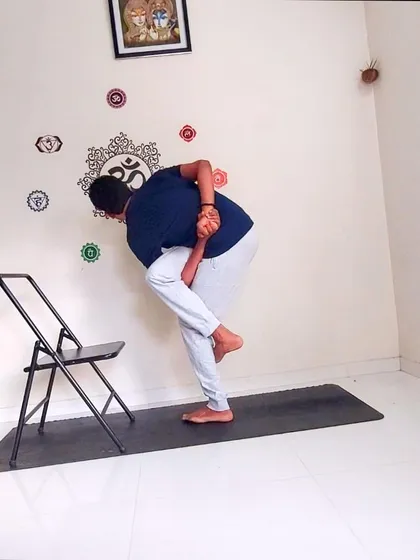 Even advanced asanas can be adapted for the office. This is a variation of Parivrtta Svarga Dvijasana (Revolved Bird of Paradise Pose) using a chair, demonstrating how I make yoga accessible to all. This is a core part of my chair yoga sessions, designed to build strength, balance, and flexibility for desk-bound professionals.
