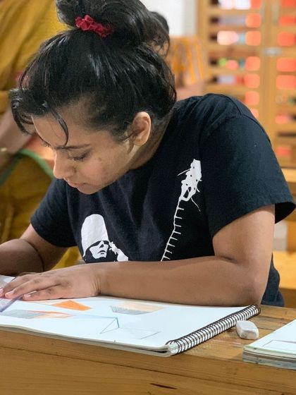 With guidance from our instructor, a student practices perspective drawing, a key skill for any aspiring artist.