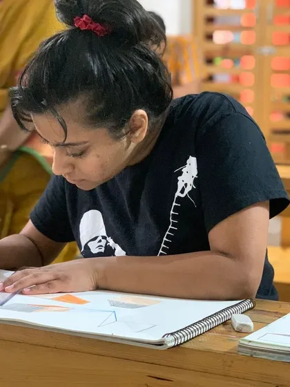 With guidance from our instructor, a student practices perspective drawing, a key skill for any aspiring artist.
