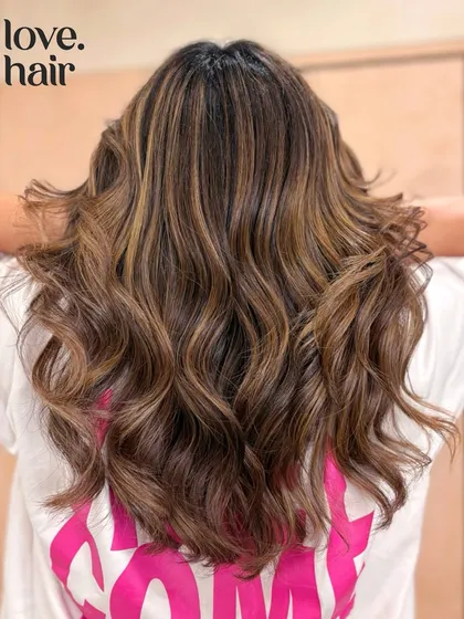 Caramel butterscotch with a little spice. This look combines warm caramel and butterscotch tones for a sweet and sassy balayage.