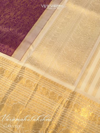 The contrast between the heavy purple brocade pallu and the elegant cream body with gold stripes.