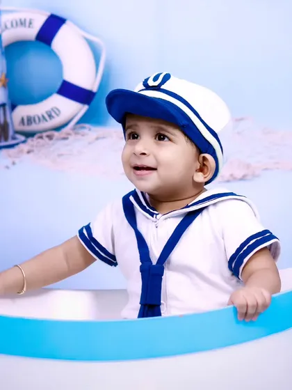 A close-up portrait of a sweet baby boy in a sailor costume.