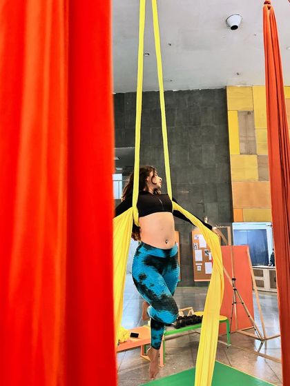 A moment of poise between movements. Even simple holds on the silks are a great workout and help build endurance.