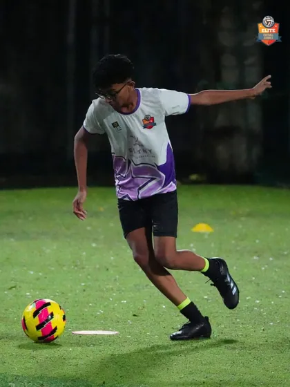 A player practices his passing technique. Repetition and focus are key to mastering the basics.