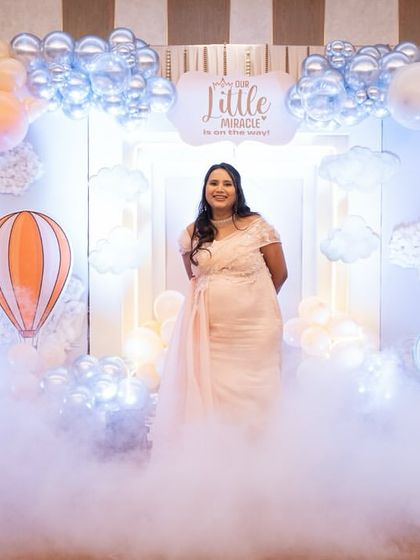 The glowing mom-to-be standing amidst the dreamy dry ice clouds. This effect makes for absolutely stunning photographs and adds a touch of ethereal beauty to the event.