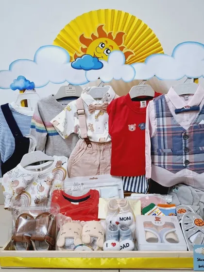 My 'Sunshine' theme is perfect for bringing a little brightness to the celebration. Here, I've arranged a complete wardrobe for a little boy, including formal wear with a bow tie, casual outfits, and adorable 'I love Dad' booties, all displayed on a custom rack.