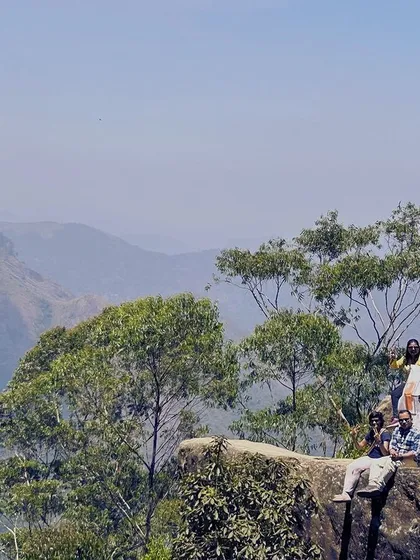 The group posing at a viewpoint in Kodaikanal, with the vast mountain range behind them.
