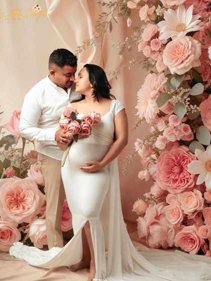 A romantic moment surrounded by flowers. This beautiful studio setup is perfect for capturing the love story behind the baby bump.