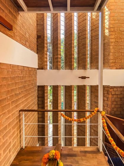 The vertical slats of the pivoted windows in the Divyadarshan home, creating a visual connection to the greenery outside while maintaining privacy.