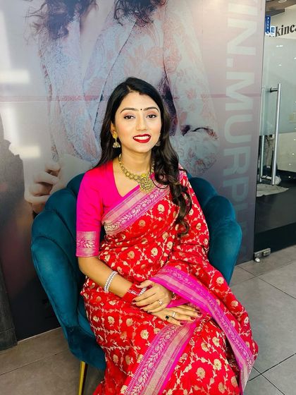 A classic party look for a client in a red Banarasi saree. I opted for a bold red lip, winged eyeliner, and soft waves to create a timeless and elegant appearance.