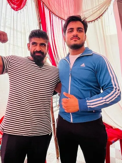 With a fellow powerlifter at the NPC district competition. The community and sportsmanship are a big part of the sport.
