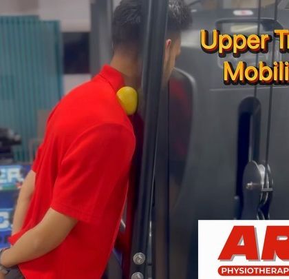 This image demonstrates an upper trapezius mobilization technique using a small ball. This simple exercise can be highly effective for releasing tension in the neck and shoulder area, a common issue for those with desk jobs.