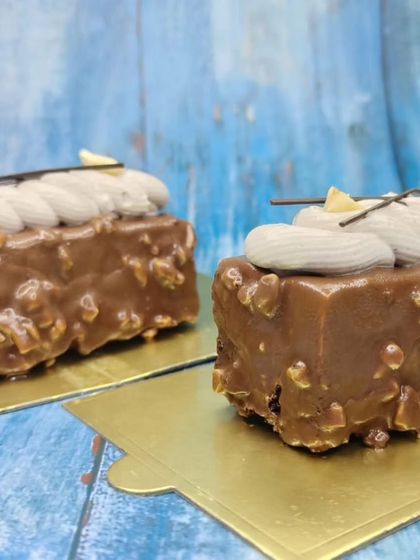 A close-up of the hazelnut mousse, highlighting the crunchy nuts and smooth chocolate coating.