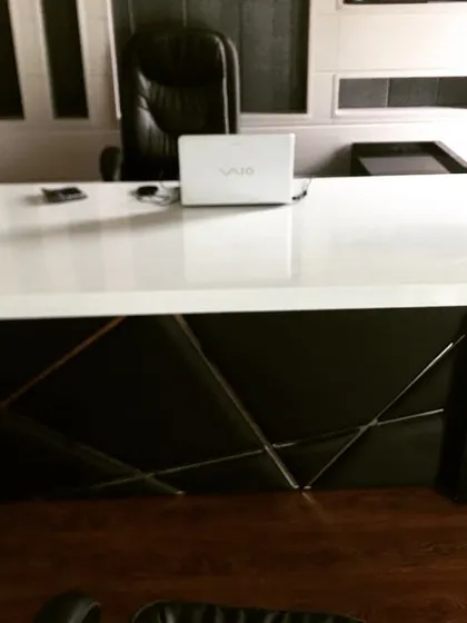 Here is a custom-made executive table with a glossy white top and a contrasting black leather-paneled base. This piece shows how I can tailor office furniture to create a bold, sophisticated look.