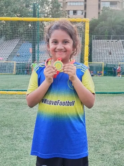 This young girl's smile shows the pride of being named Player of the Month.