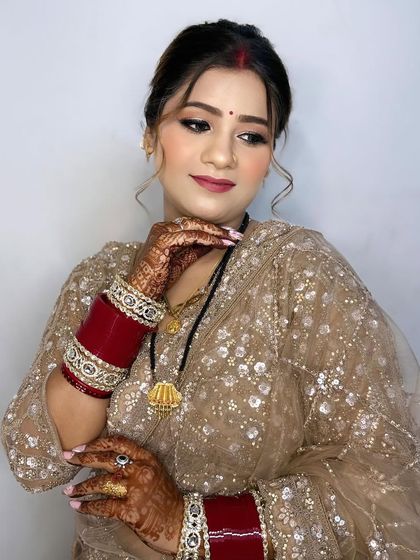 A beautiful pose showing off her flawless makeup and intricate henna design.