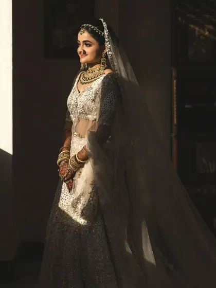 The play of light and shadow creates a dramatic and beautiful bridal portrait. We love capturing these artistic shots.