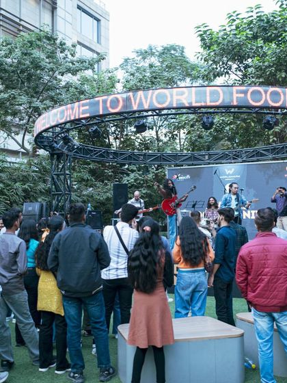 A live band energizes the crowd at the World Food Carnival. This shot captures the festival's vibrant atmosphere, where great food is paired with fantastic live music performances.
