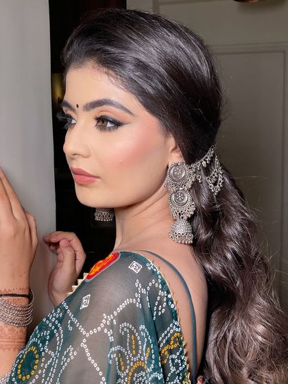 A side profile of this subtle desi look. The sharp winged eyeliner and nude lip are a classic combination that always looks good.