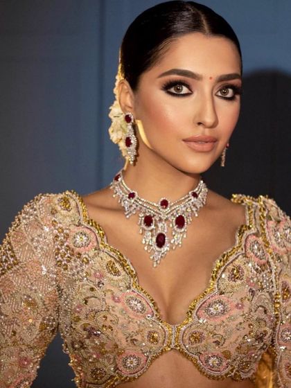 A full-face portrait of the regal reception look, showing the balanced and harmonious makeup.