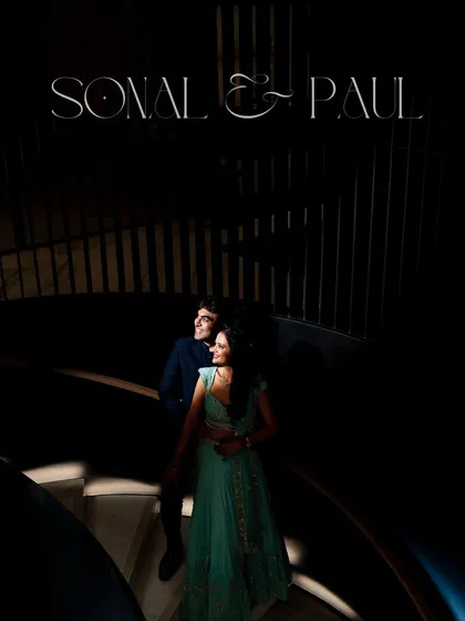 A dramatic, moody portrait of Sonal and Paul on the spiral staircase. We love using architectural elements and creative lighting to create unforgettable engagement shots.