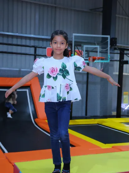 Balancing act on the trampoline. This young lady shows off her poise while enjoying the fun of our jumping zone.