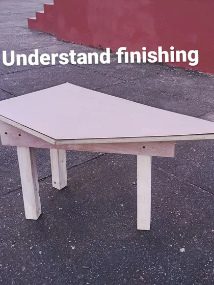 A single triangular table piece, sanded and ready for finishing. Each team was responsible for creating their part of the larger puzzle.