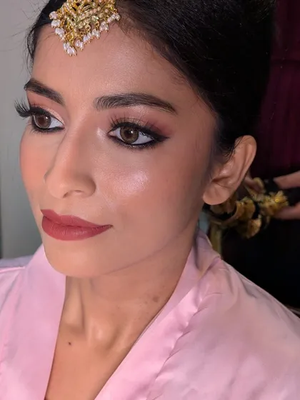 A behind-the-scenes shot of Afrin's makeup application, focusing on creating that signature glowing skin and soft, romantic eye makeup.