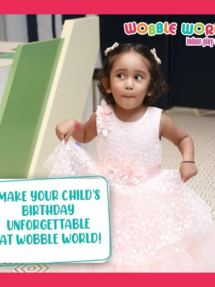 A little girl in her beautiful party dress, ready to enjoy her unforgettable birthday at Wobble World.