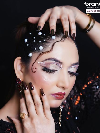 A close up of the pearl effect makeup, showing the delicate placement of each pearl around the eyes and in the hair. This requires immense precision and patience.