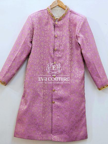 A simple and elegant men's sherwani in a lavender Banarasi silk. The collar and cuffs are detailed with fine gold embroidery.