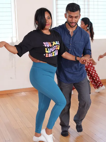 Two students practicing their connection during a Bachata class. Our goal is to teach you how to communicate with your partner through dance, creating a smooth and enjoyable experience.