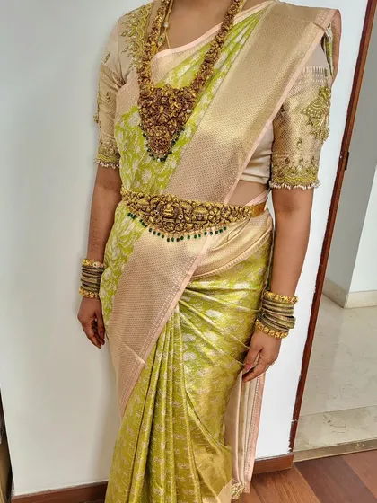 Another angle of the drape for bride Megha, showing how the pallu is set and the pleats are secured under the waistbelt, ensuring a perfect look from every side.
