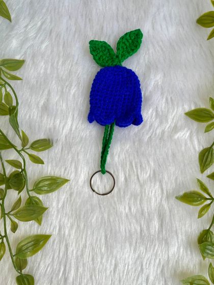 A single dark blue tulip keychain. The simple design and bright color make it a lovely little accessory.