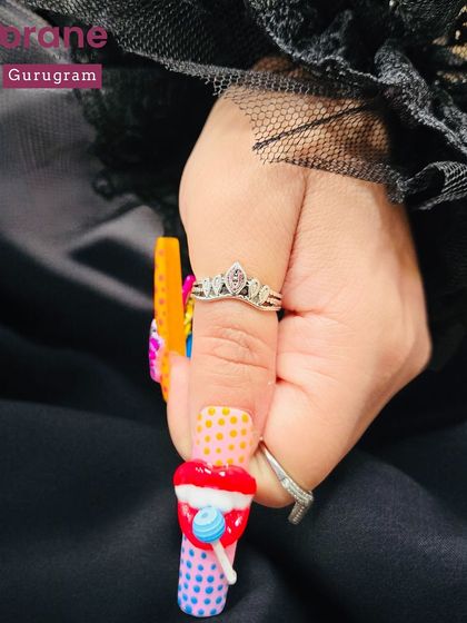 A fun and colorful set of "Pop Art" nails with 3D candy and ice cream elements. This shows the playful and creative side of nail artistry.