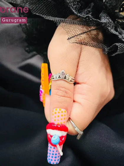 A fun and colorful set of "Pop Art" nails with 3D candy and ice cream elements. This shows the playful and creative side of nail artistry.